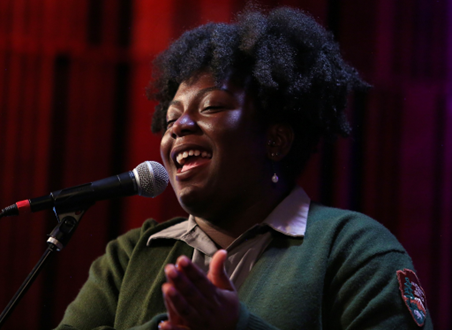 Ranger Jade Perdue of the Arrowhead Jazz Band at New Orleans Jazz National Historical Park singing into a microphone.