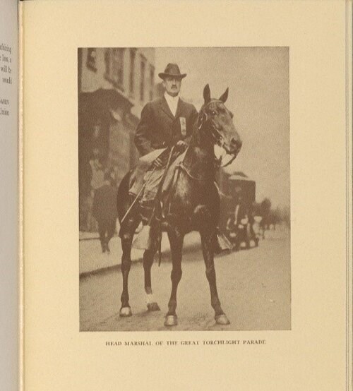 A man in a black suit and hat sits on a black horse (black and white photo) Schlesinger Library
