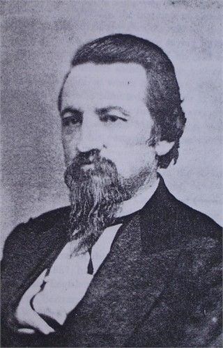 A black and white image of a Chrisman with beard and facial hair.