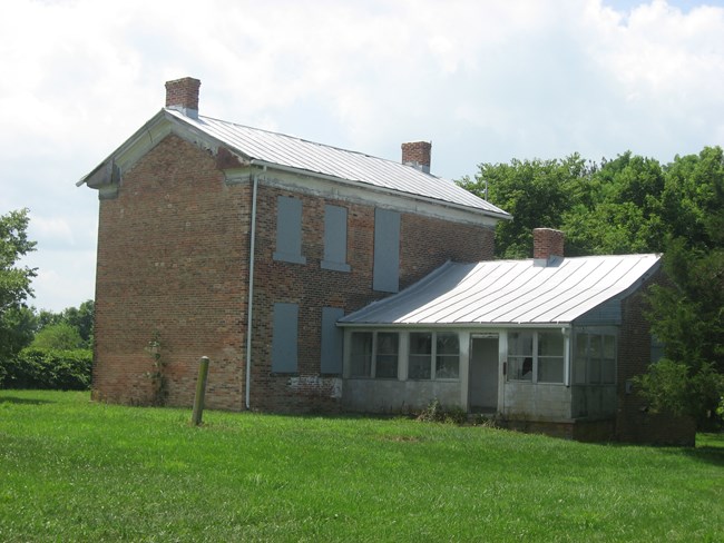 Two-story brick farmhouse.