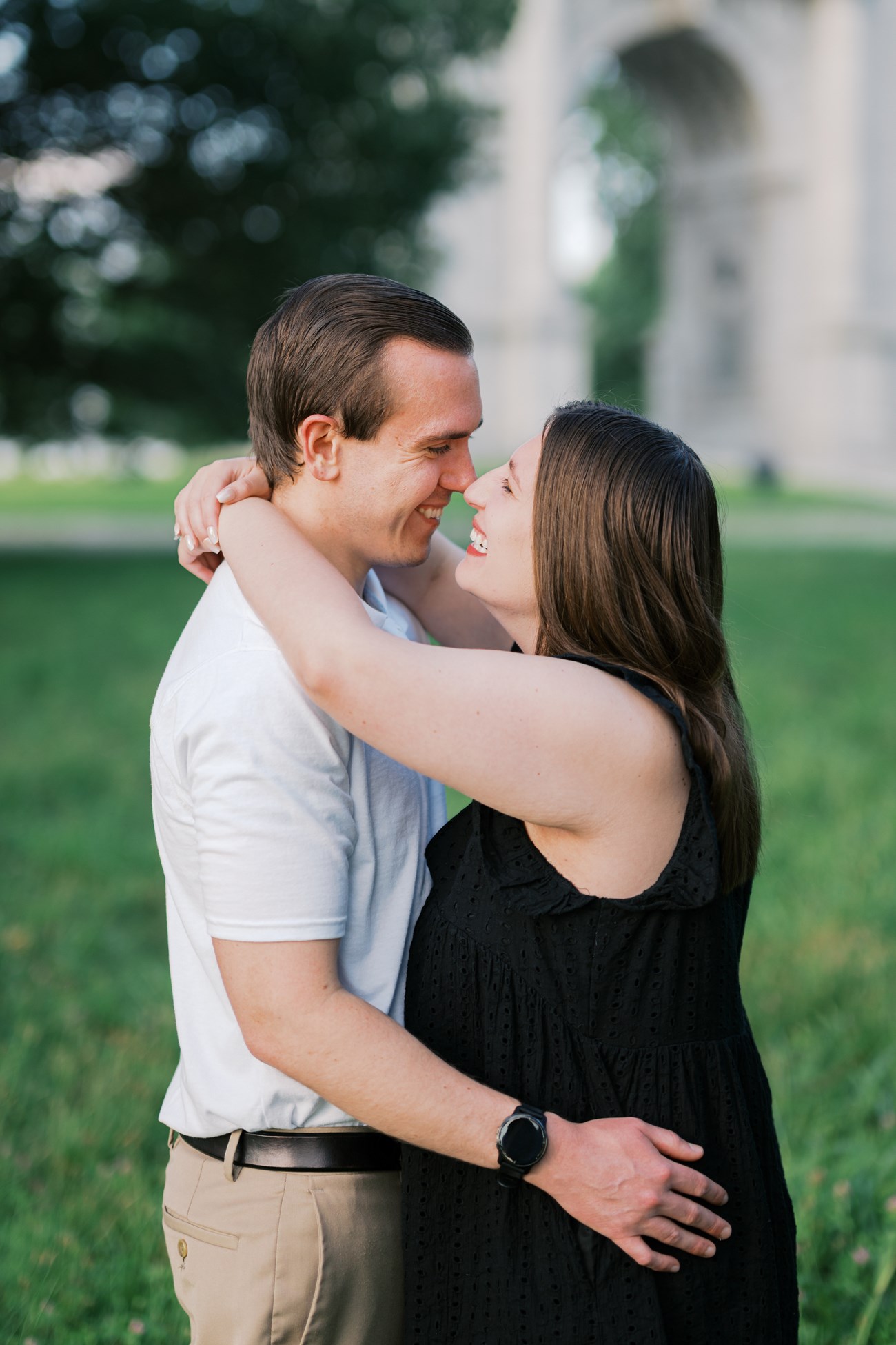 A couple embrace with similes on their faces.