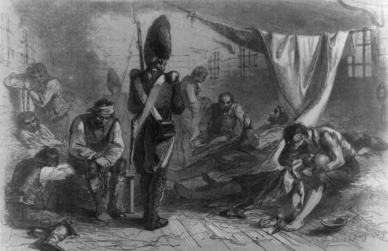 An illustration of a British soldier standing amid prisoners on a ship.