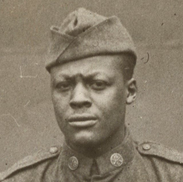 African American Soldier wearing World War One uniform looking at the camera