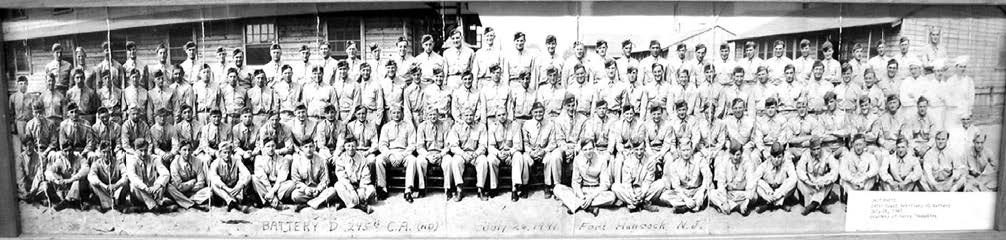 a group of one hundred men in uniform sit in three lines