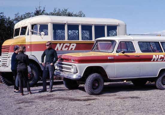 KATM Buses at VTTS Road 1968 Three people stand near the front of a jeep and a bus, both painted cream with a red and yellow stripe.