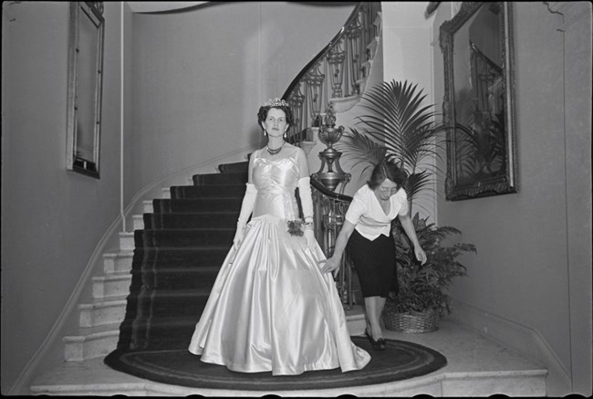 Rose Kennedy stands in ball gown.