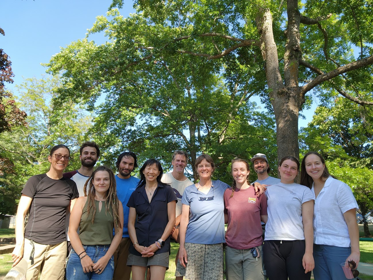 Klamath Network staff and field crew members gather for a photo. Several smiling people gather for a photo during a picnic.