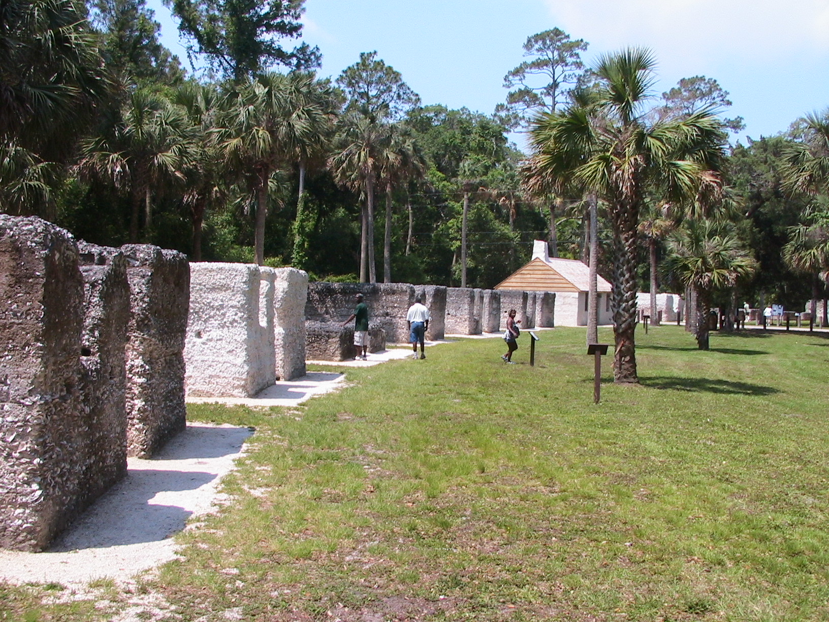 white tabby cabins with no roofs in a semi-circle