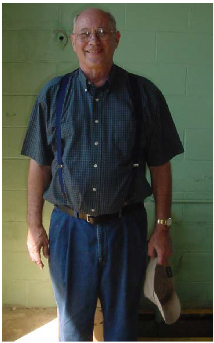 smiling man in blue shirt and pants