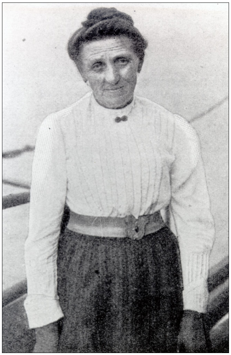 A woman standing in front of a body of water