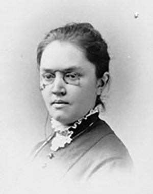 Black and white portrait of a woman wearing glasses