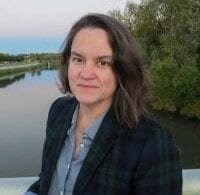 Professor Kathryn Holliday Photo of the speaker Kathryn Holliday with a river landscape in the background.