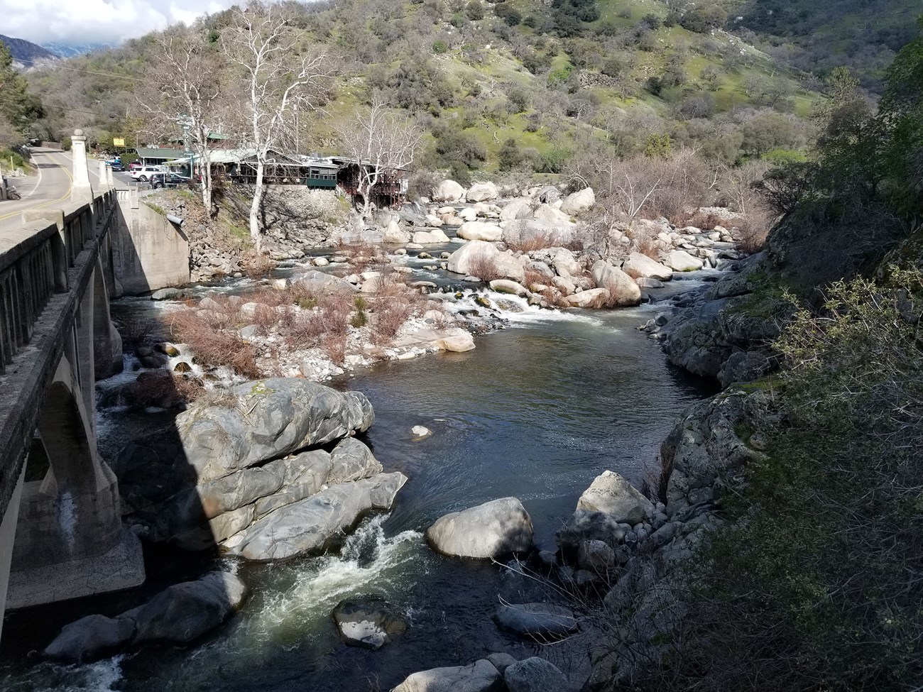 View of Kaweah River from bridge with low enough flow that all large rocks are visible, and water is clear, not muddy.