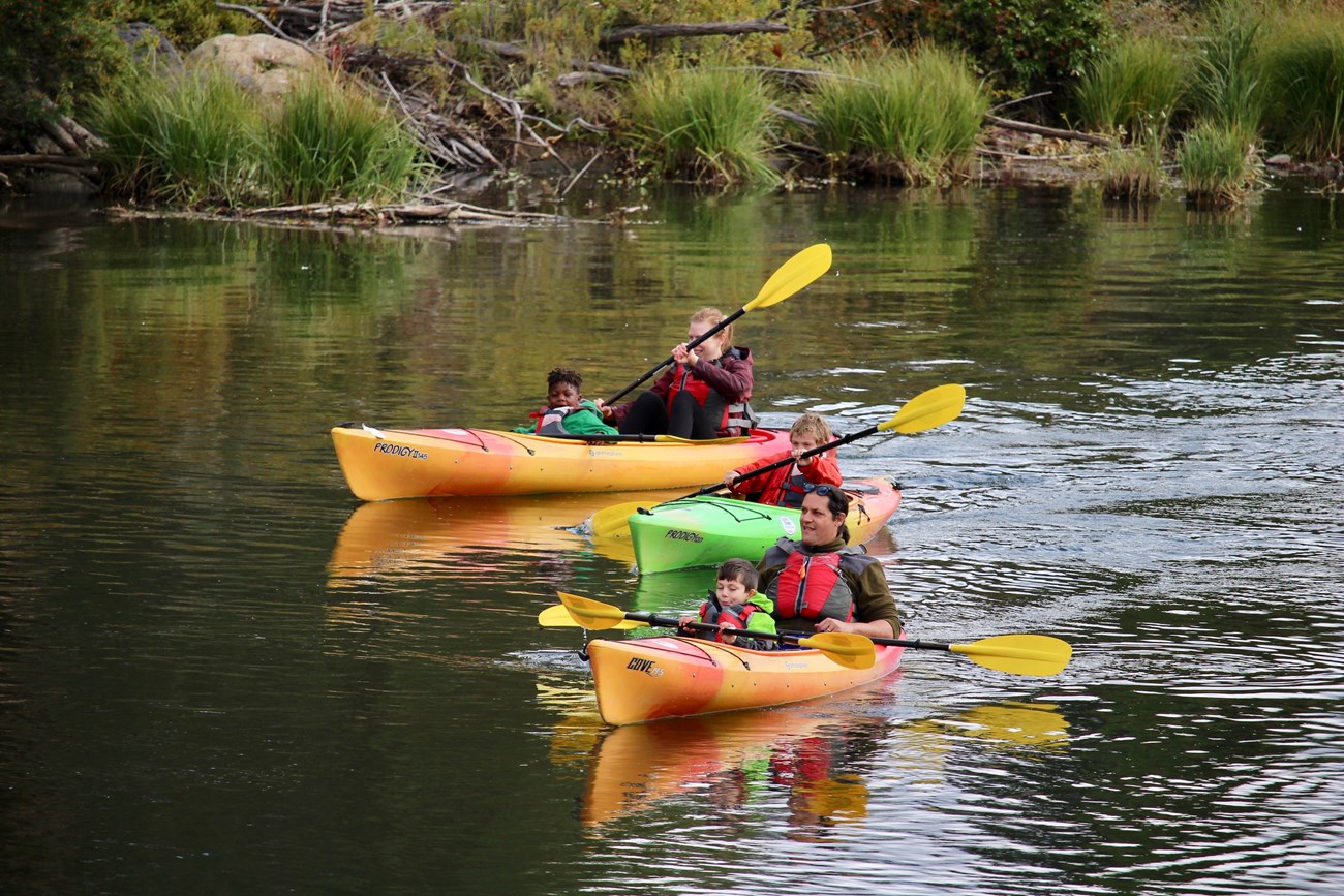 A family kayaking on the Deschutes River.