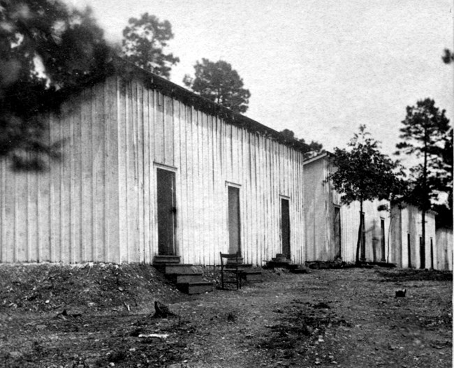 Three large bathhouses surrounded by trees