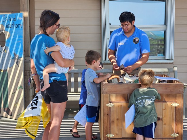 A park ranger talks with a group at the touch box