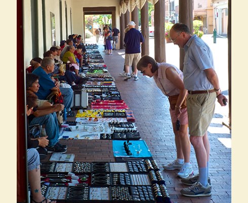 Native artists from more than 41 pueblos and tribes exhibit and sell art, jewelry and other works daily under the Palace of the Governors portal. Photo © Jack Parsons