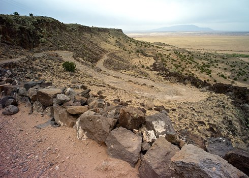 The volcanic escarpment of La Bajada Mesa, one of New Mexico’s most spectacular natural landmarks, looms 600 feet above a southward stretch of windswept plains. Photo © Jack Parsons