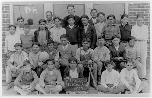 B&W Photo of teacher and young students