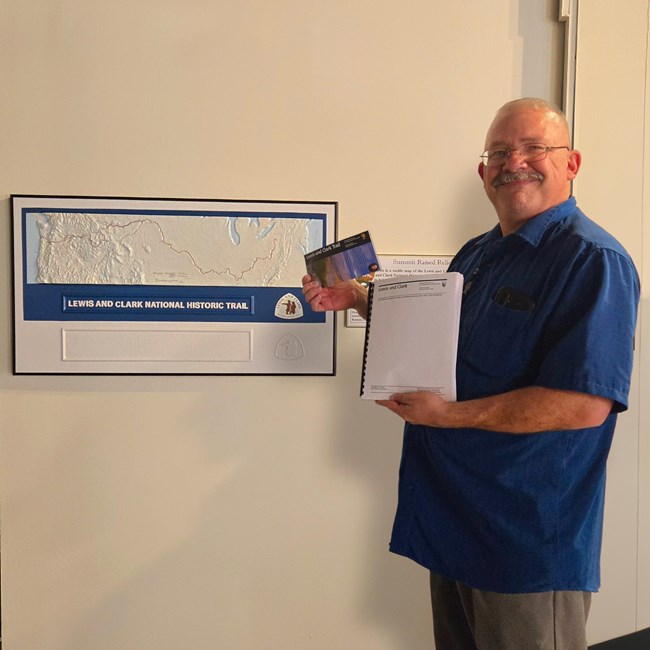 a man holding a tactile map