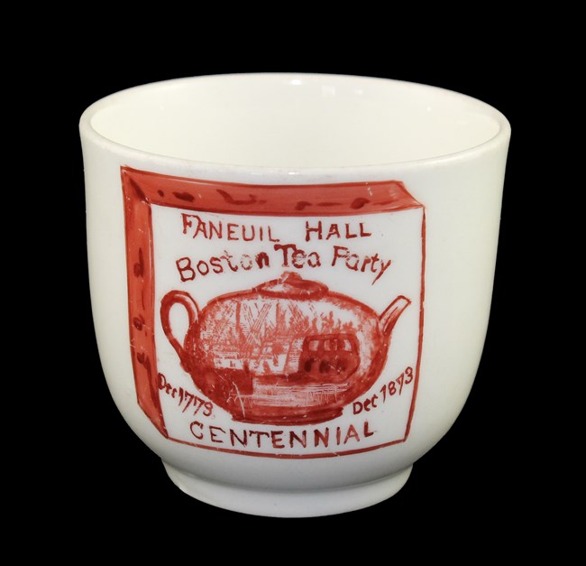 LONG 18023 White teacup with red printed decoration of a teapot and ship captioned Boston Tea Party Centennial