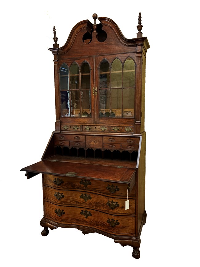 LONG 2466 Dark wooden desk with lower drawers, fold-out desk top, and top section with glass-fronted bookcase