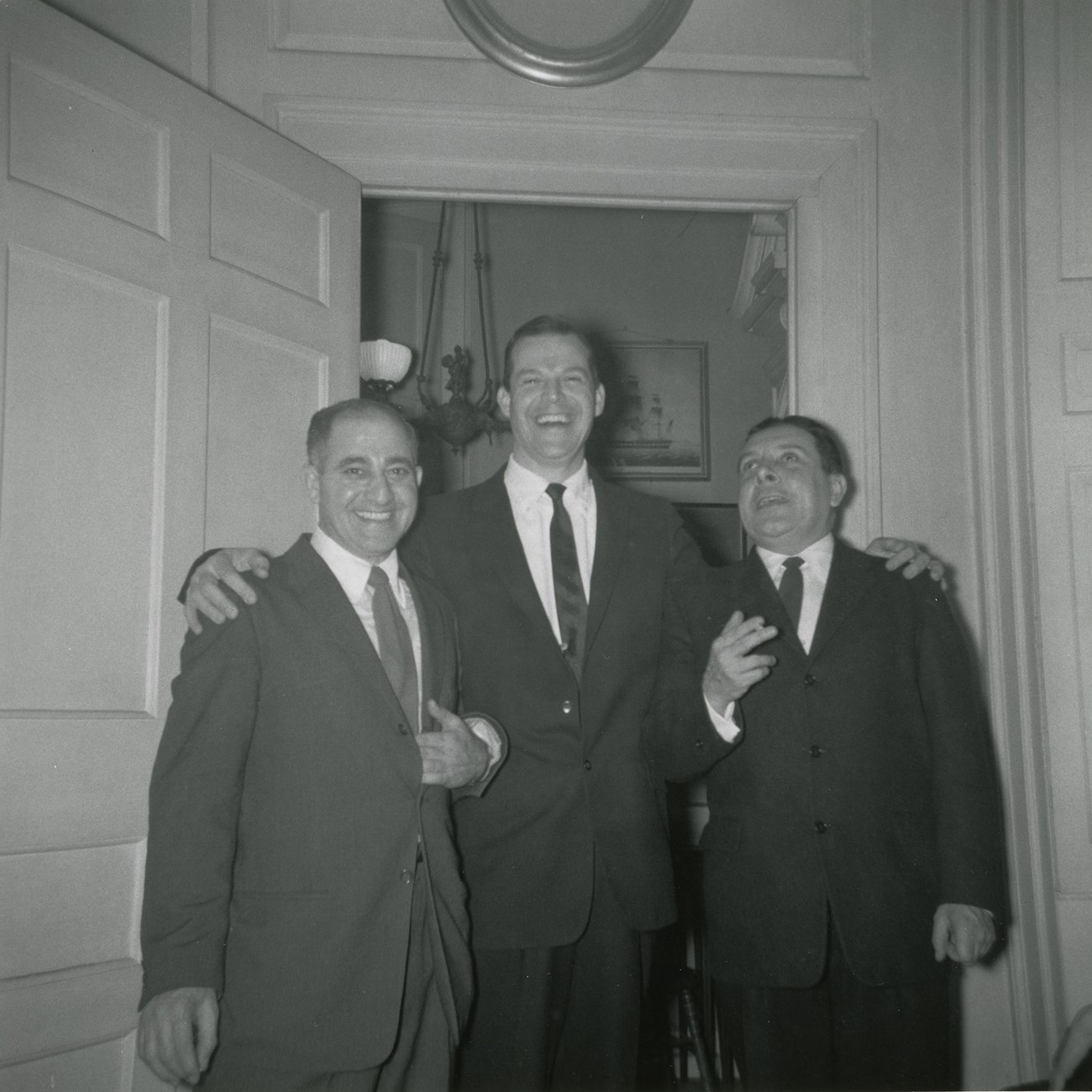 Henry W. Longfellow Sesquicentennial Black and white photograph of three men in suits in front of doorway