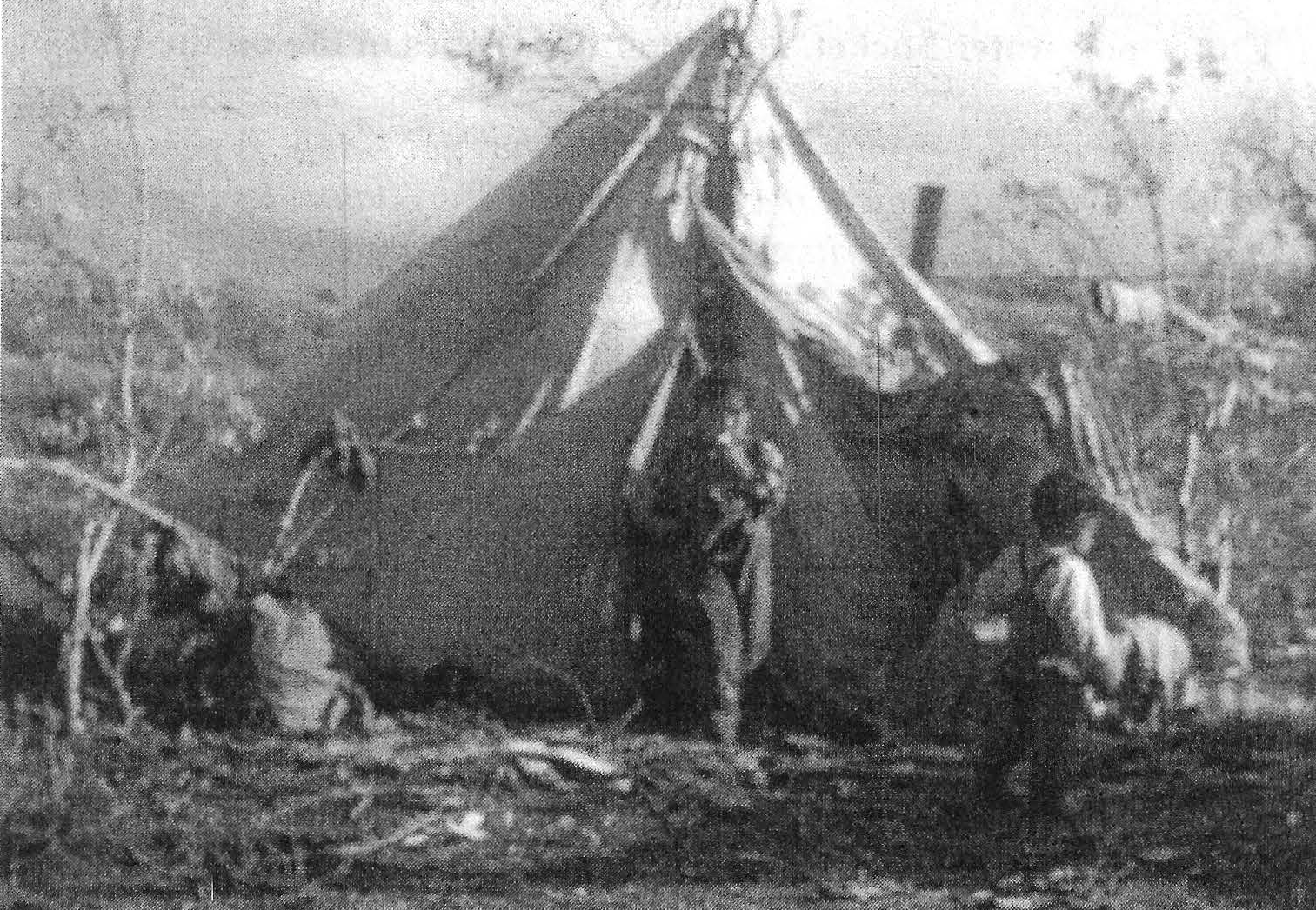 Black-and-white photograph of Nunamiut children and a wall tent on the tundra Black-and-white photograph of Nunamiut children and a wall tent on the tundra