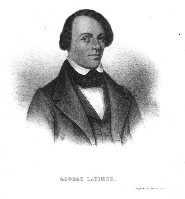 Portrait of a young man who wears a black suit with white shirt and a bowtie. His hair is parted to the side.