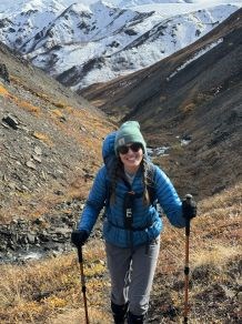 Laura Vachula Female hiker with hiking poles smiling at the camera