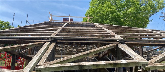 An angled wooden support structure for a roof that has been removed.