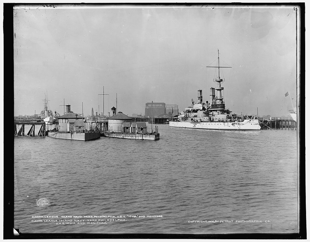 Ironclad-type ships to the left and a more modern, twentieth century ship to the right, all docked at the PNYA. Library of Congress Control Number 2016800225.