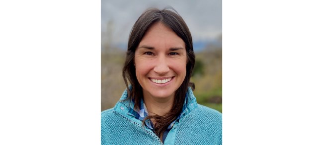 Christy Leonard Leonard smiling outside in a teal fleece.