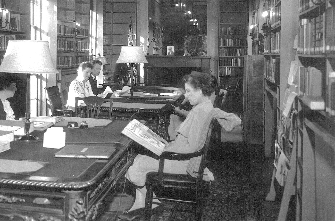 Library_1943.001.013 Several people seated at tables reading in NWP library