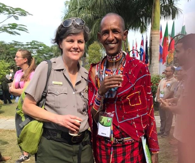 LInda Bennett standing next a representative from a Kenyan national park