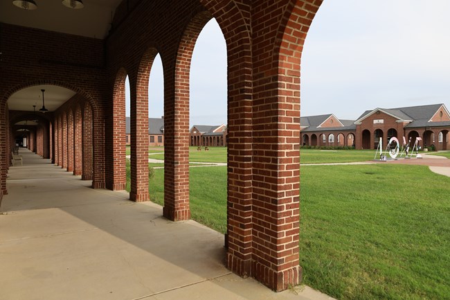 Looking through a brick archway.