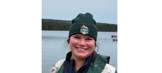 Headshot of smiling woman in green hat with Scientists in Parks logo