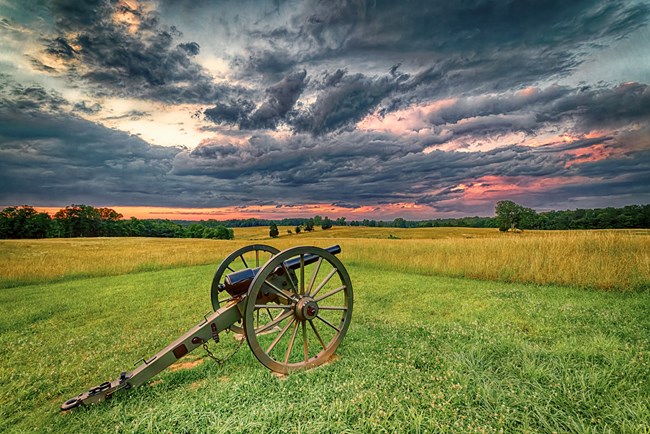 Cannon on Henry Hill a lone cannon on a grassy field with pink cloudy sunset above