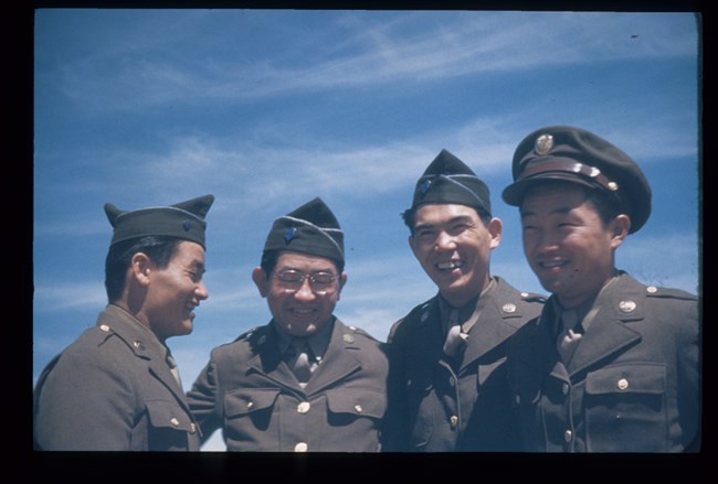 MC19 Four men in military uniforms smiling