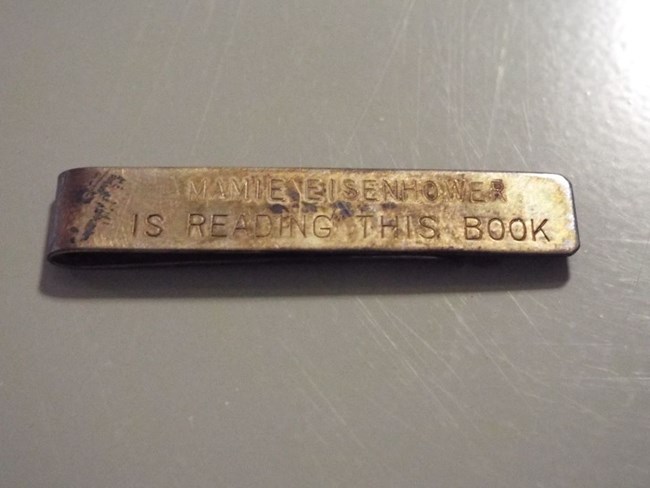 Color image of a silver bookmark used by Mamie Eisenhower