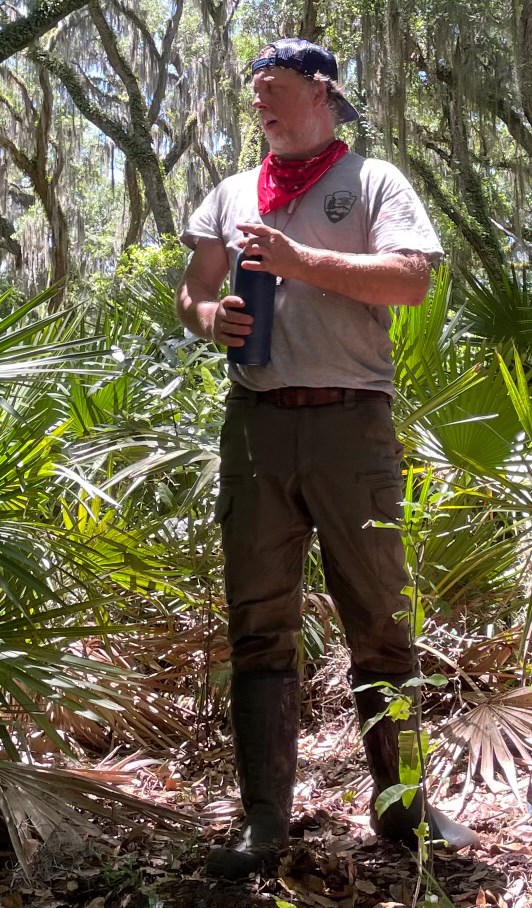 SECN Botanist M. Forbes Boyle Man with hat on backward standing in trees