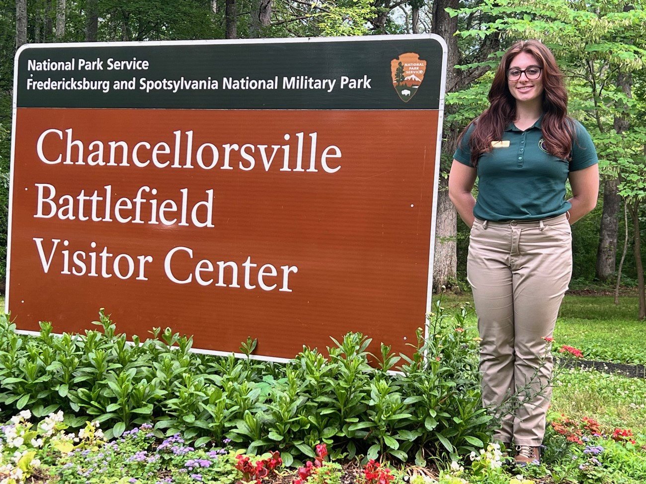 FRSP Intern Mackenna Caruso Fredericksburg and Spotsylvania National Military Park summer intern Mackenna Caruso, standing next to the sign for the Chancellorsville Battlefield Visitor Center.