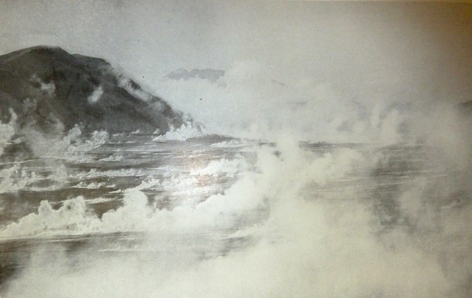 Main-Arm-of-the-Valley-of-Ten-Thousand-Smokes-688-px black and white photo of numerous fumaroles steaming in a valley with mountain peak in the distance