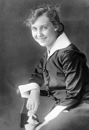 A black and white image of a teenage Mamie Eisenhower smiling