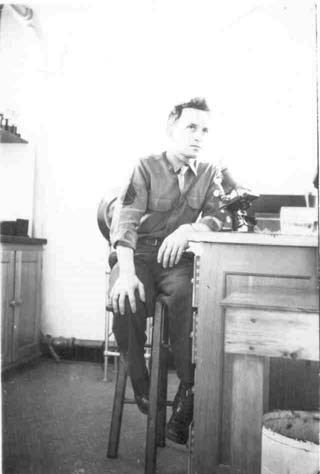 a young man sits at a laboratory desk