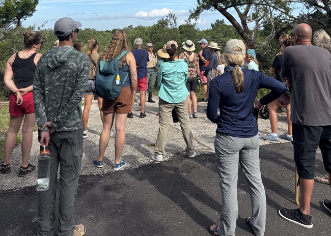 Person in uniform talking to a group of people