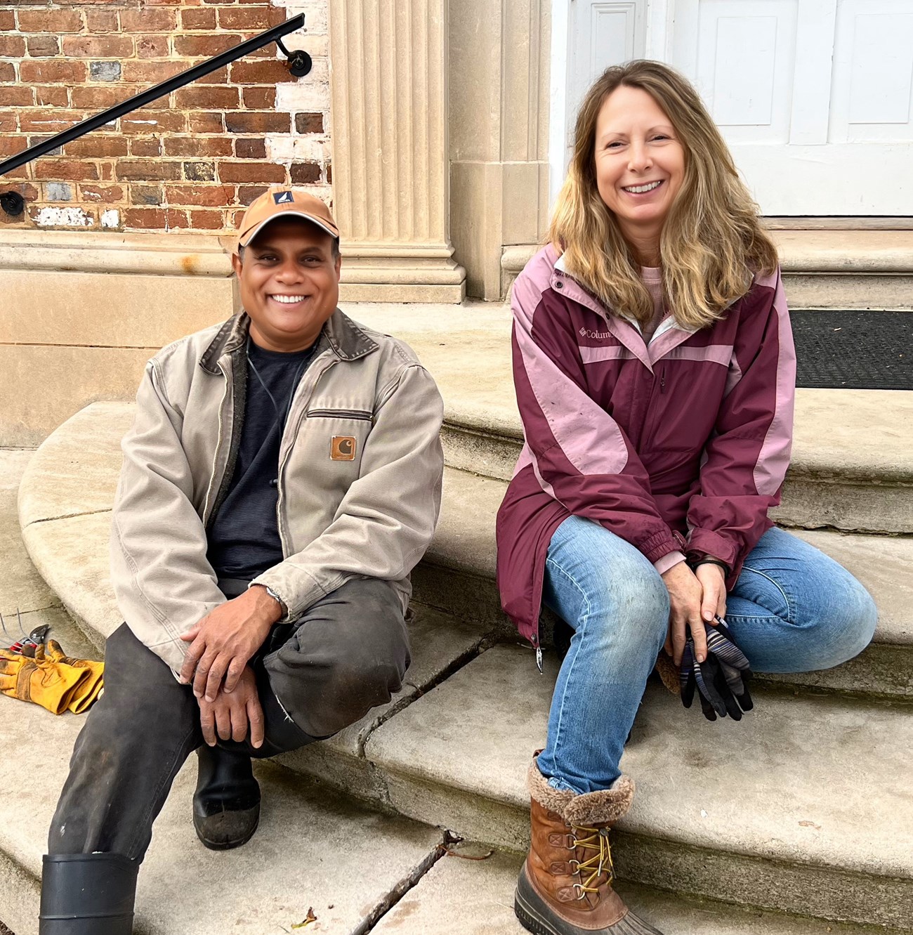 Mannon and AJ (FRSP) Chatham Garden Club volunteers Mannon and AJ, seated on stairs leading to the garden side entracnh to Chatham Manor.