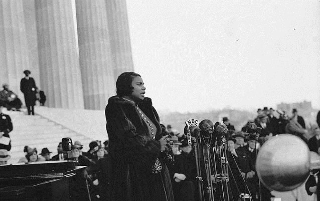 Marian Anderson sings into microphones in front of the Lincoln Memorial.