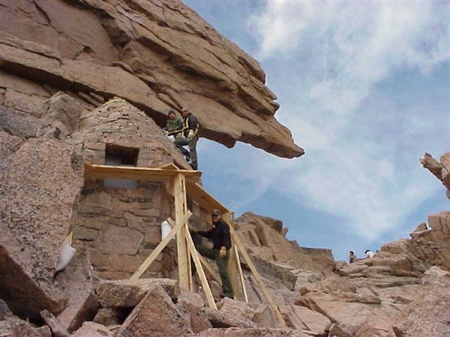 Historic preservation crew completes work on the Agnes Vaille Shelter historic structure at the Keyhole on Longs Peak, Rocky Mountain National Park Wilderness.