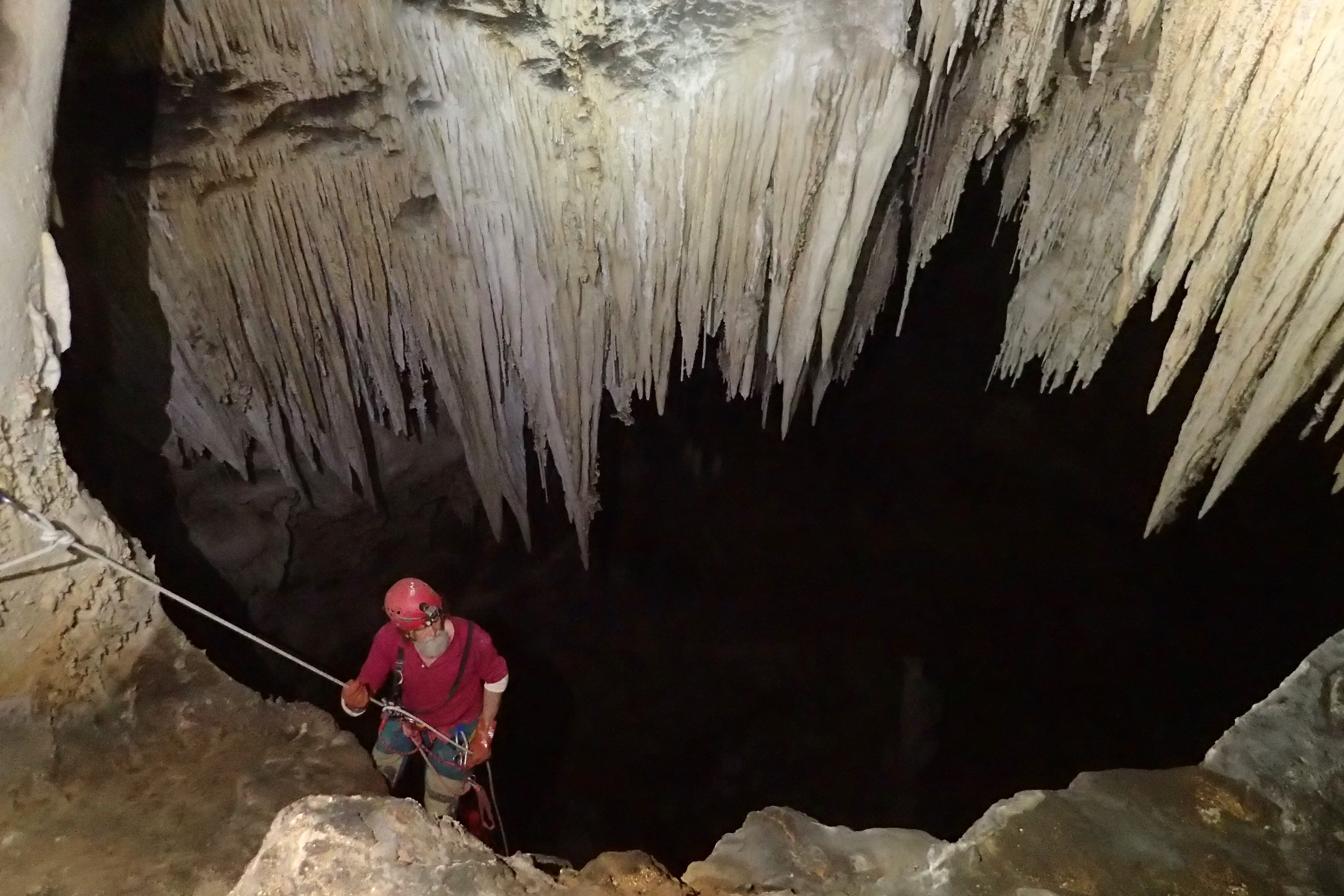 a person going down a dark passage on a rope